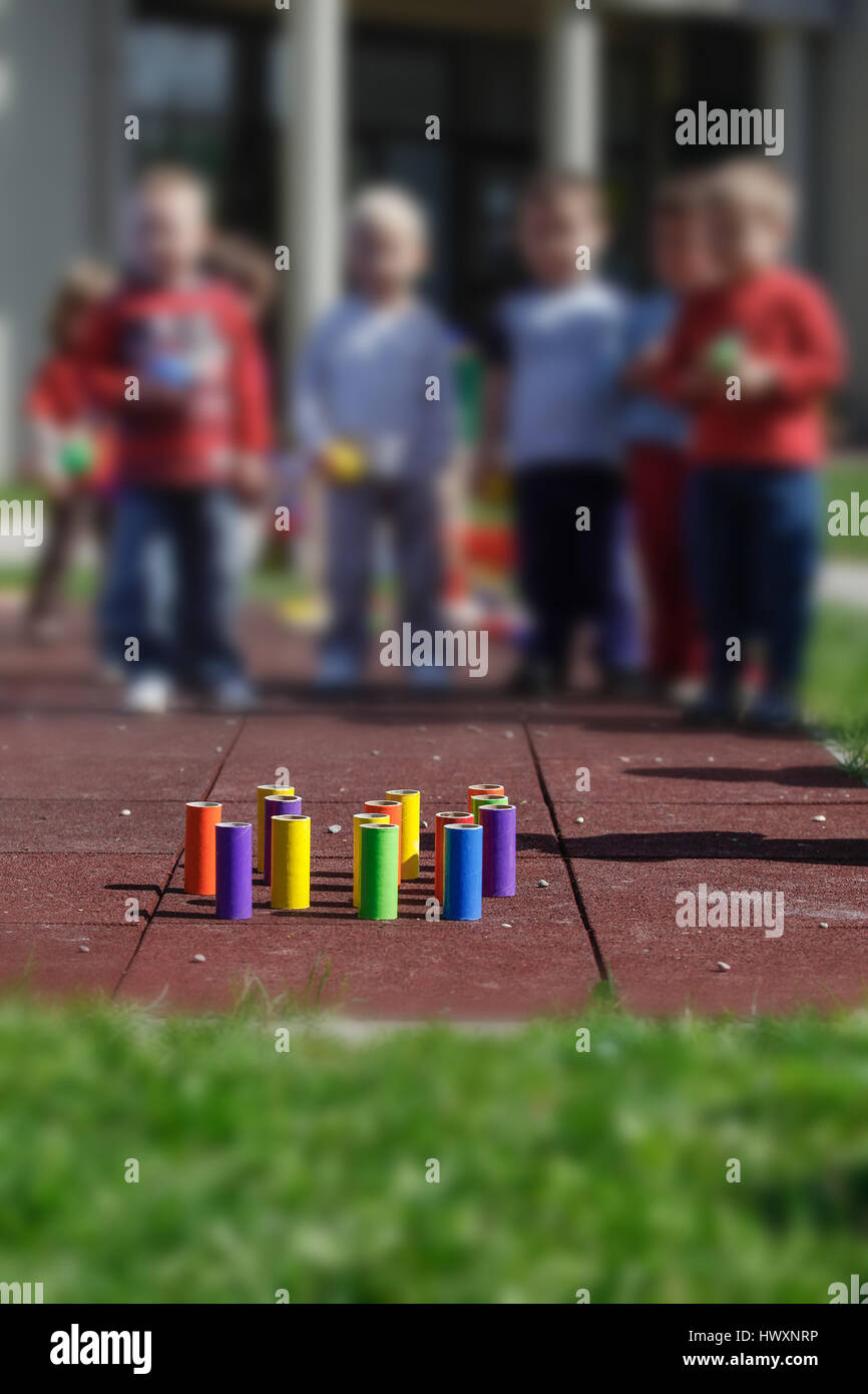 Children playing with homemade, doityourself educational toys, tube