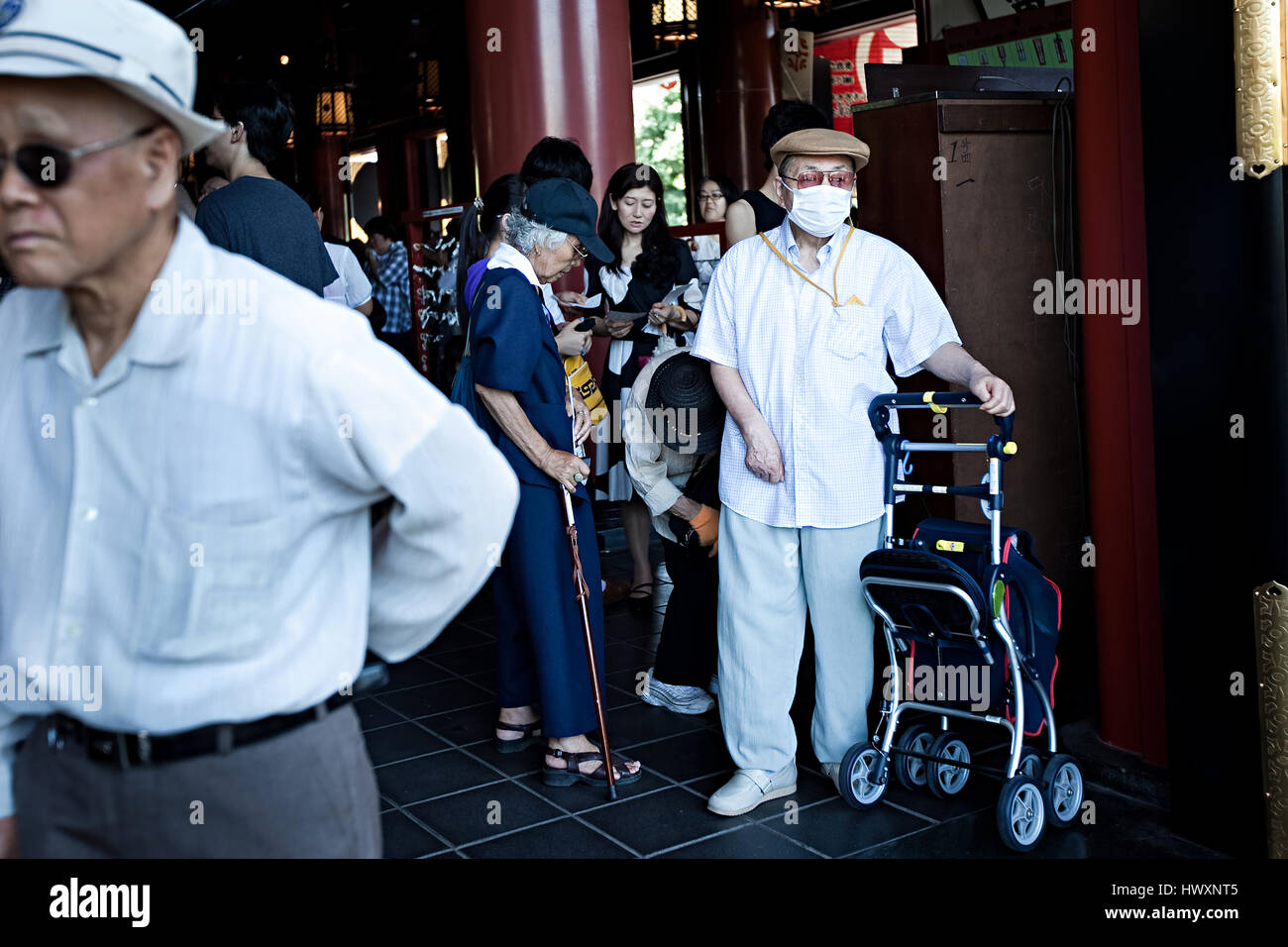 A senior is wearing a face mask in Japan. Many people in Japan are