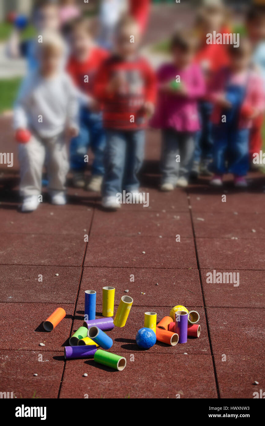 Children playing with homemade, doityourself educational toys, tube