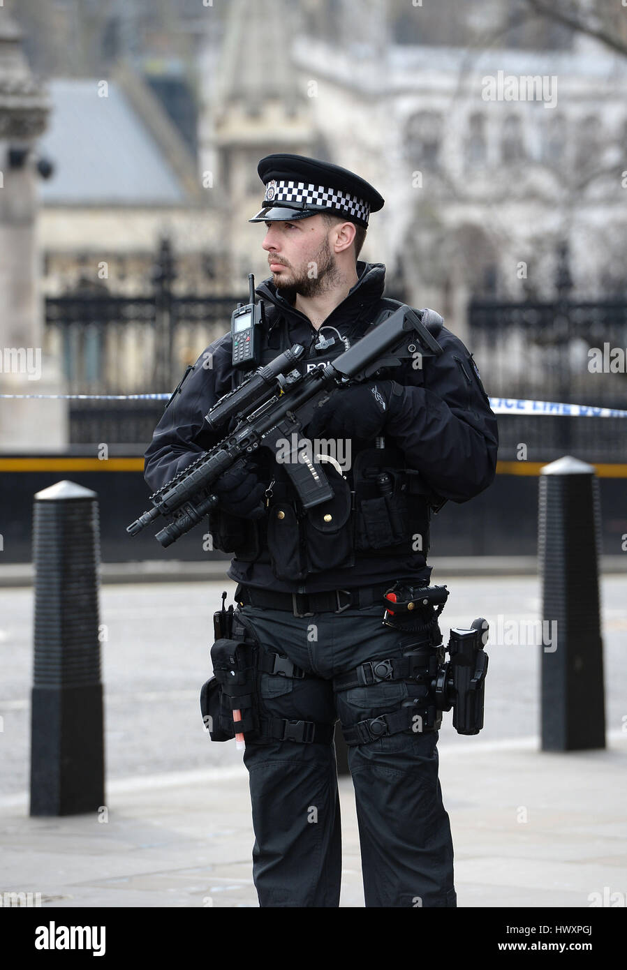 An armed police officer stands near Westminster tube station in London ...