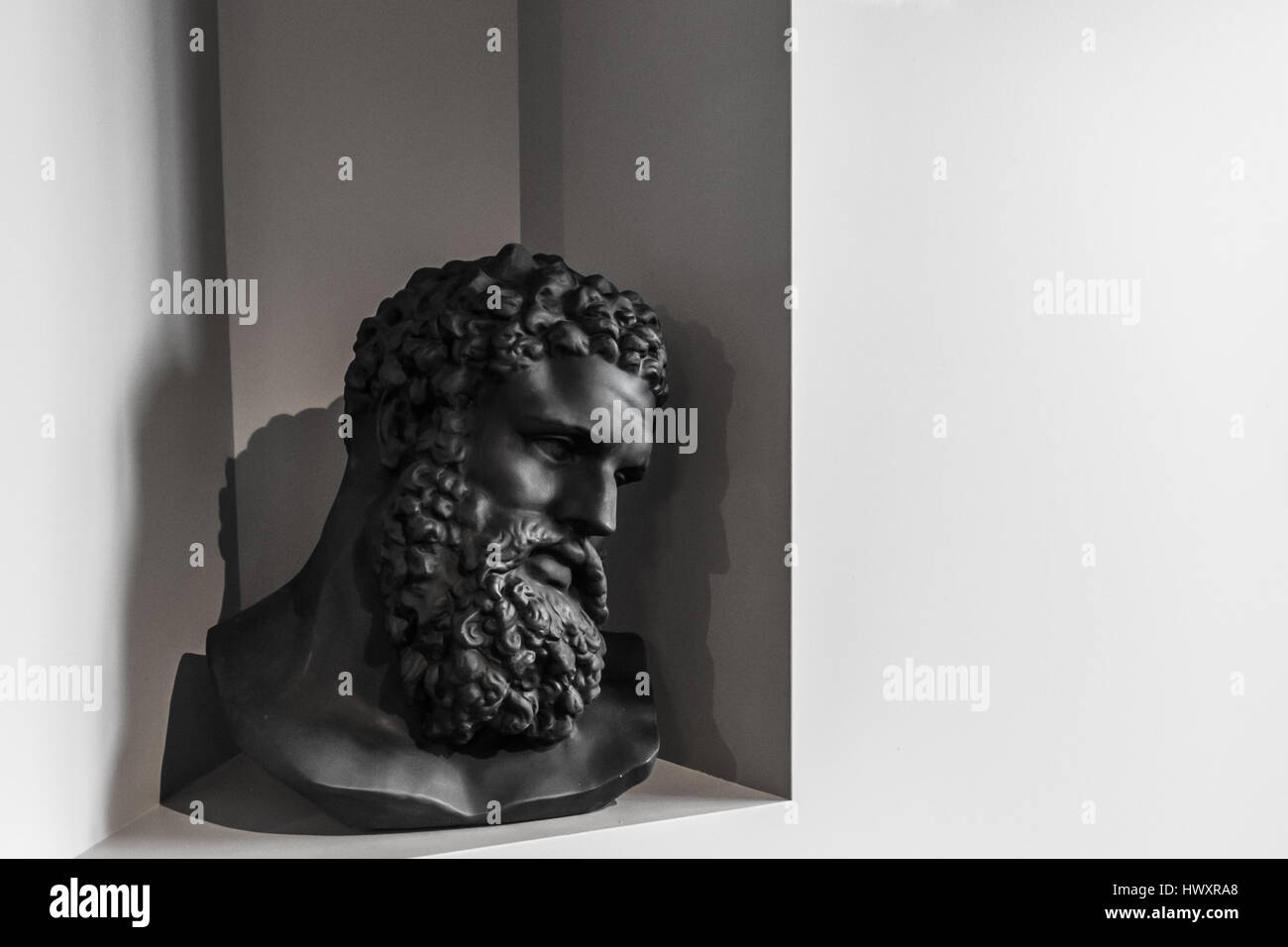 Black and white bearded man sculpture bust. Head and shoulders detail