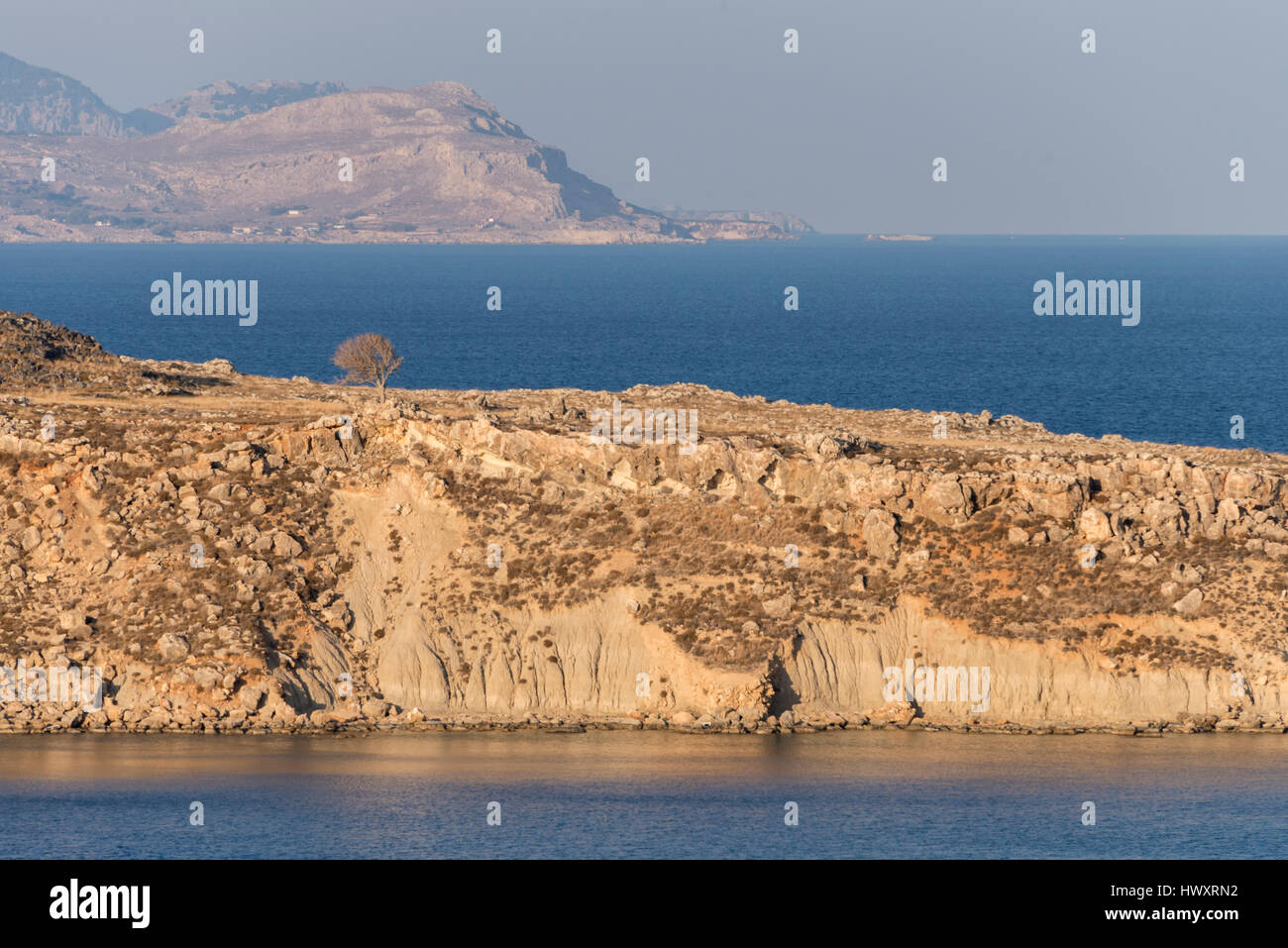 View of barren land against the sea Stock Photo