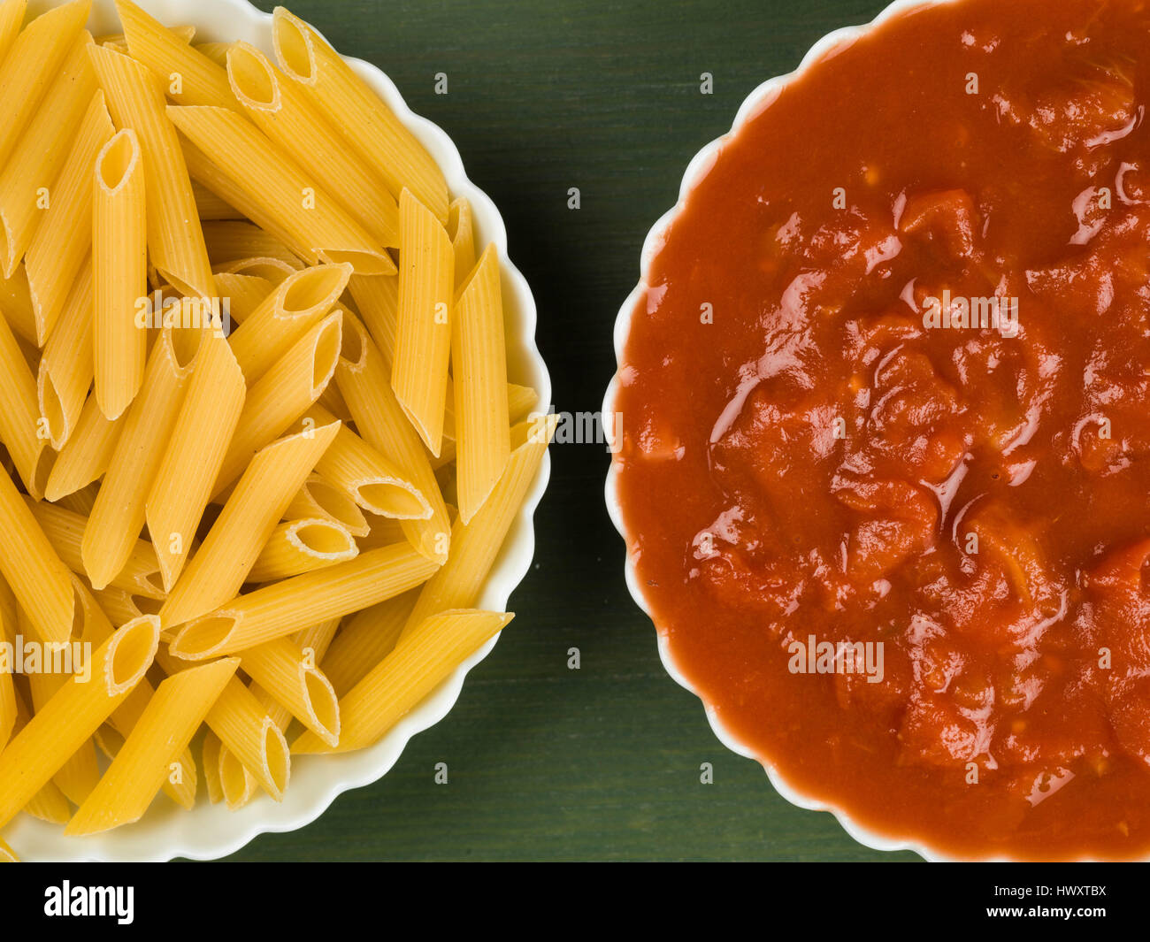 Dish of Uncooked Italian Style Penne Pasta With Chopped Tomato Against