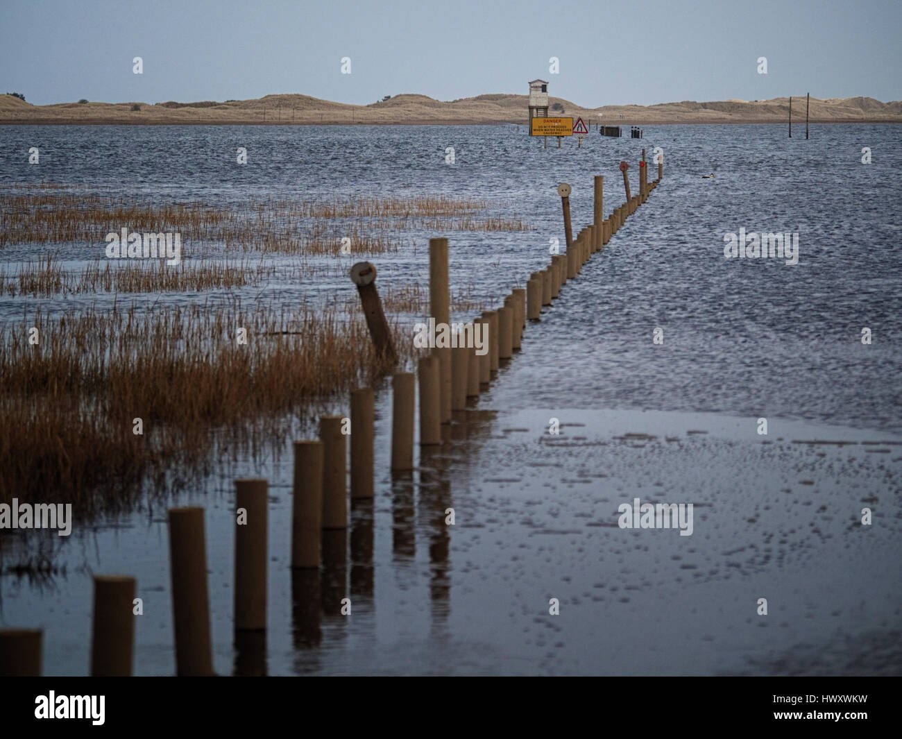 High tide on the causeway leading to the holy island of Lindisfarne, Northumberland Stock Photo