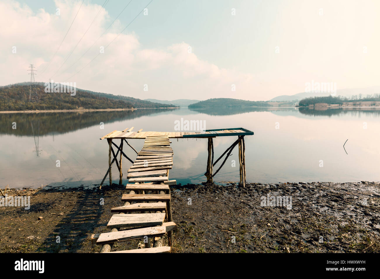low tide on the lake and a wooden dock Stock Photo