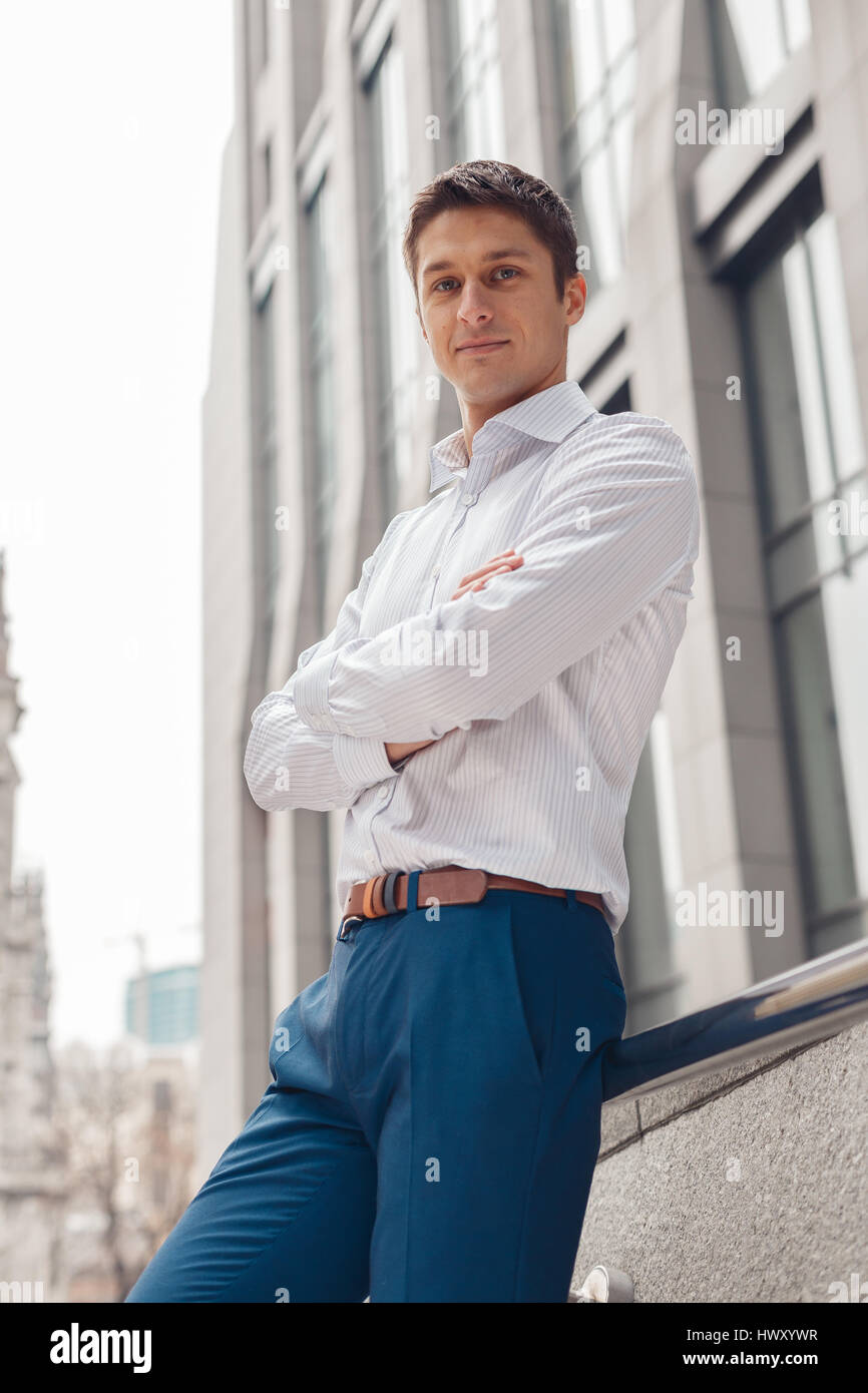 Confident young businessman in a suit standing outdoors Stock Photo - Alamy