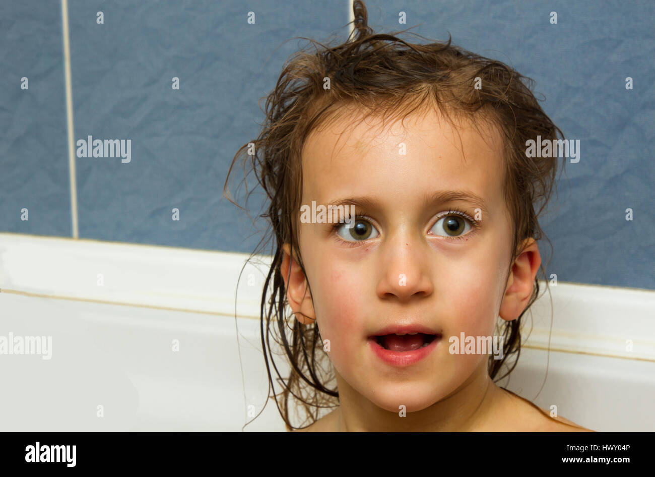 Cute little girl washes her hair. Clean kid after shower. Children ...