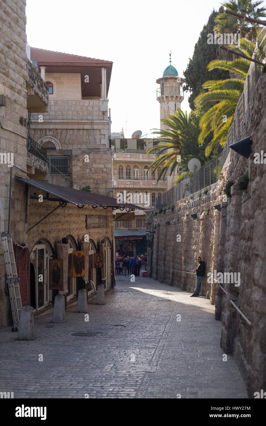 Jerusalem, Israel  - February 24, 2017: Narrow old street in Jerusalem, on the right there is a shop with religios art pieses Stock Photo