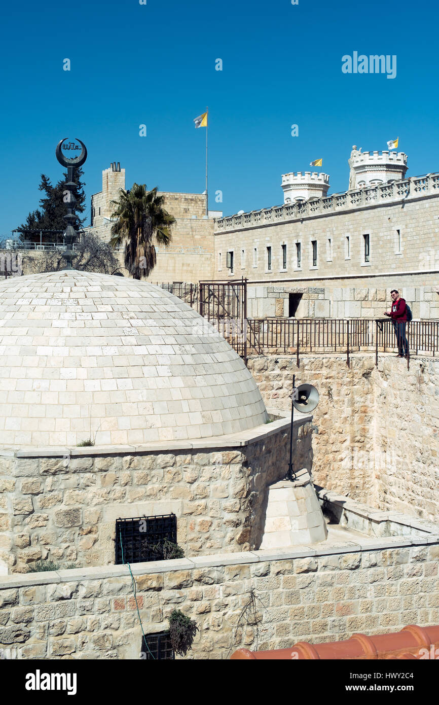 Jerusalem, Israel  - February 25, 2017: Man watching on a mosque dome from the south part of the ancient city wall Stock Photo