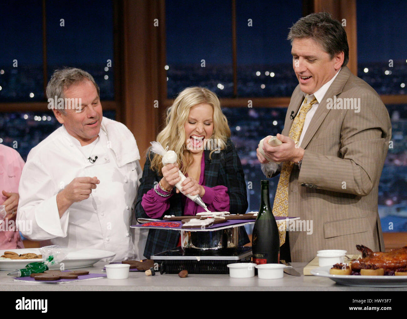 Chef Wolfgang Puck, left, actress Kristen Bell, and host Craig Ferguson