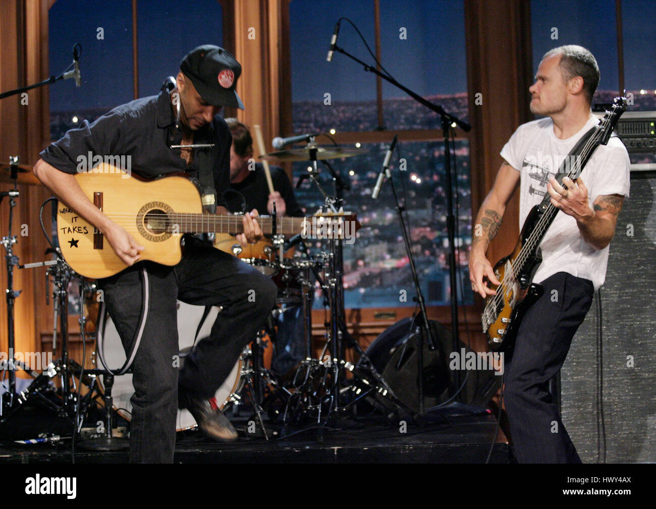 Guitarist Tom Morello, left, and Flea on bass, perform during a segment