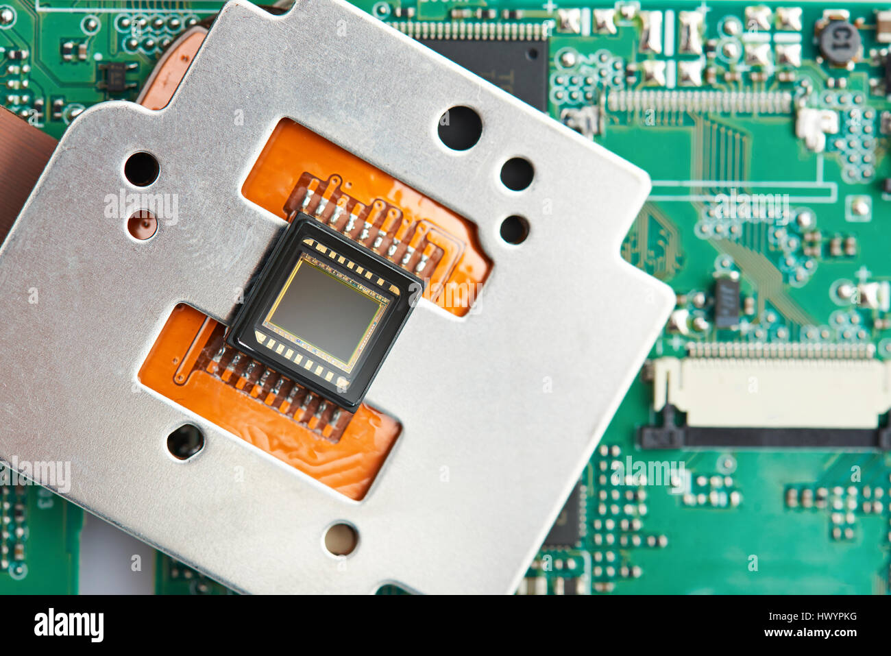 Closeup of small digital camera sensor on electronic circuit background ...