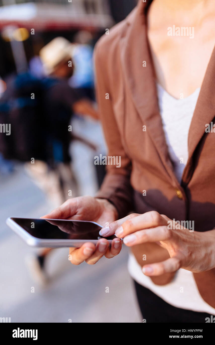 Businesswoman using cell phone, close-up Stock Photo