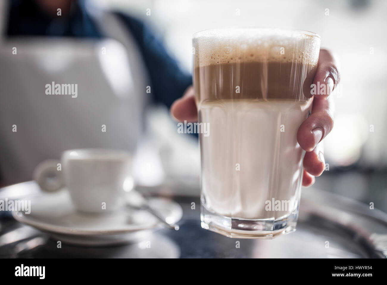 Barista serving Latte Macchiato Stock Photo