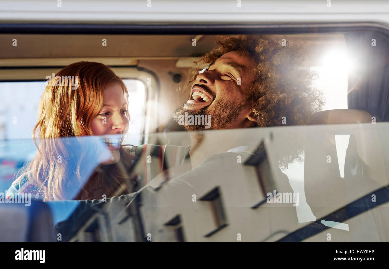 Happy young couple in a car Stock Photo - Alamy