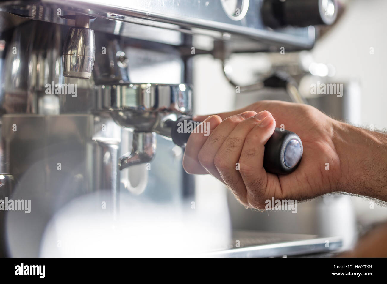 Barista using espresso machine Stock Photo