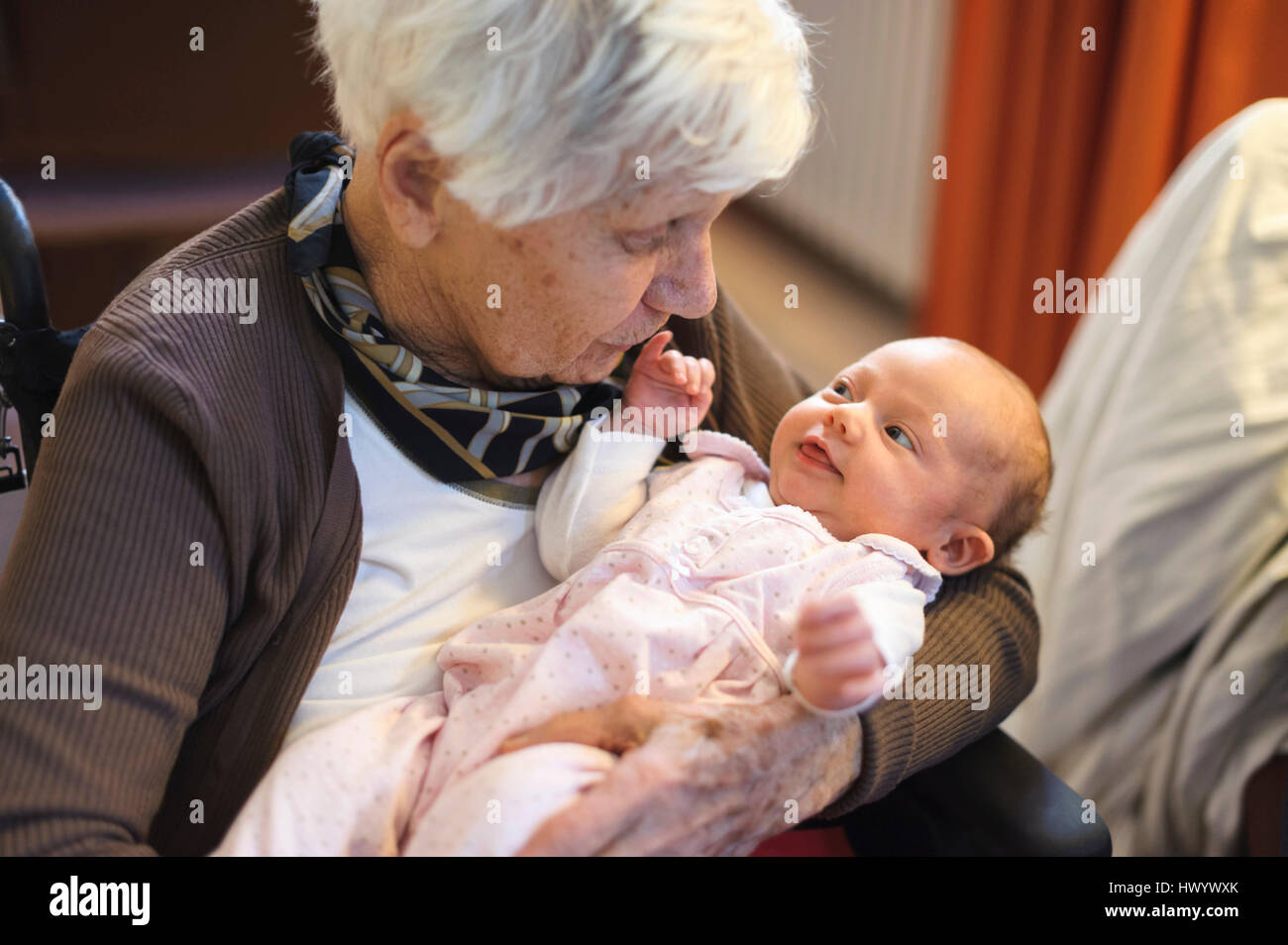 Old woman meeting her great granddaughter Stock Photo