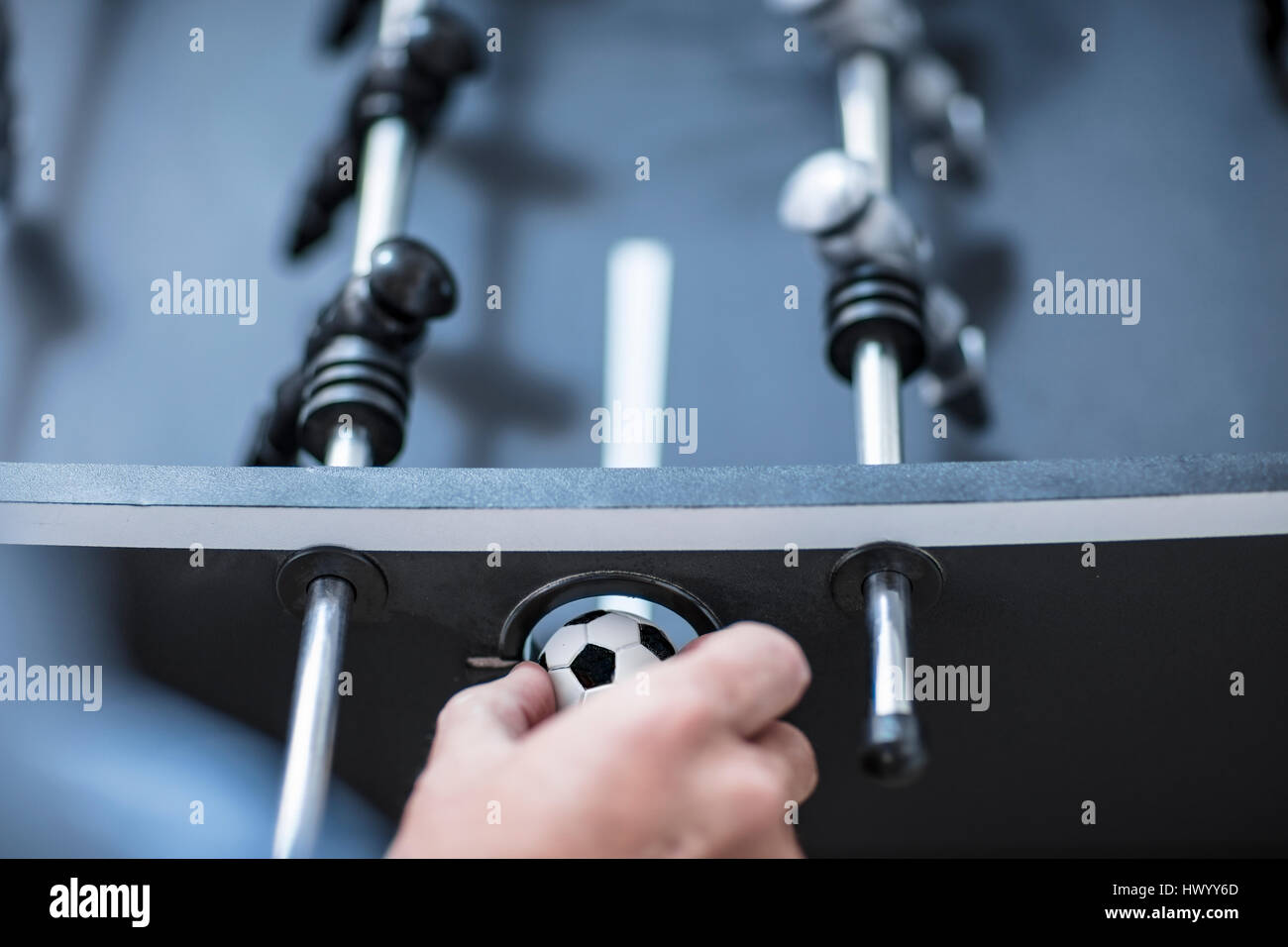 Hand and foosball table, close-up Stock Photo