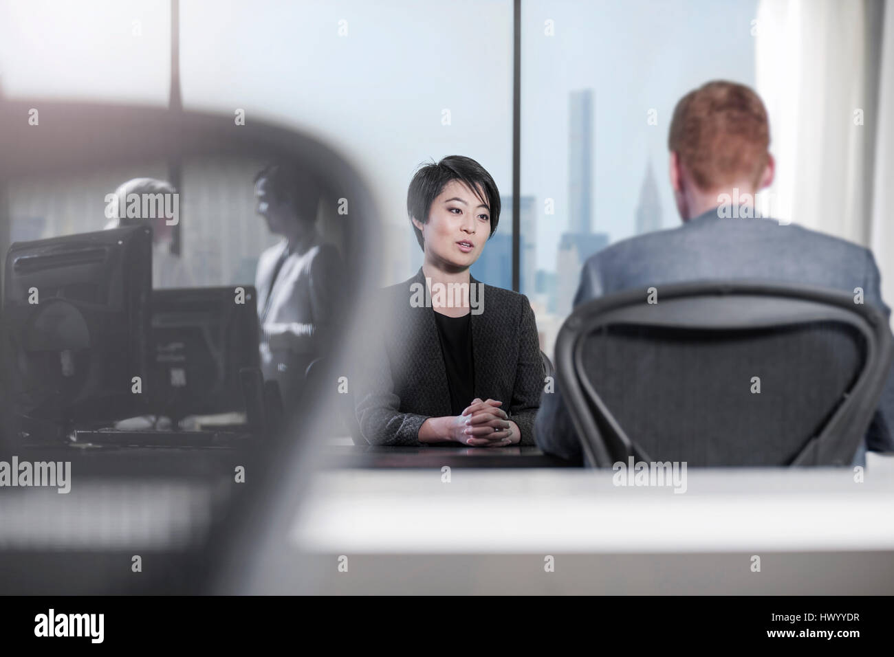 Woman and man talking at desk in office Stock Photo - Alamy