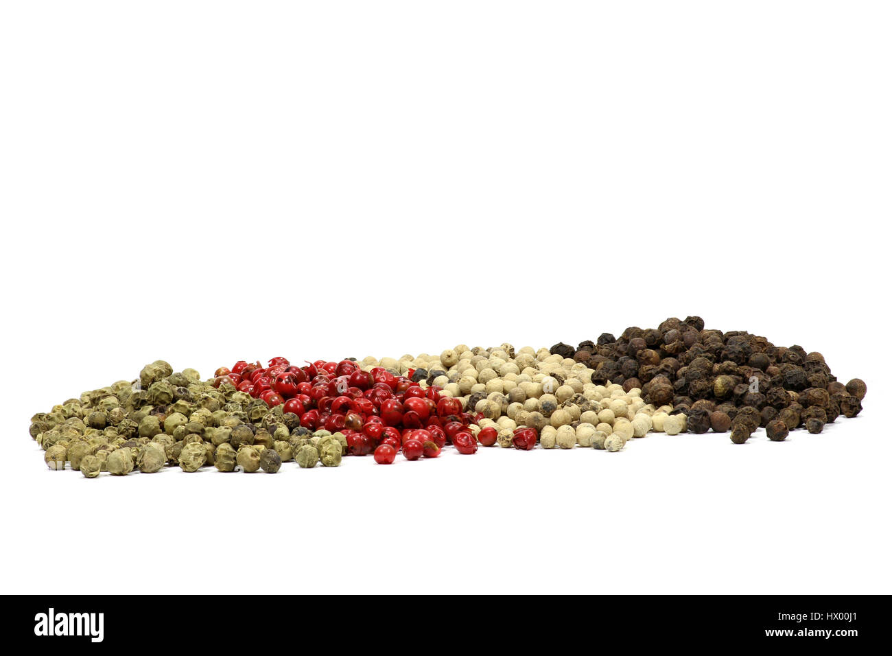 different colored peppercorns isolated on white background Stock Photo