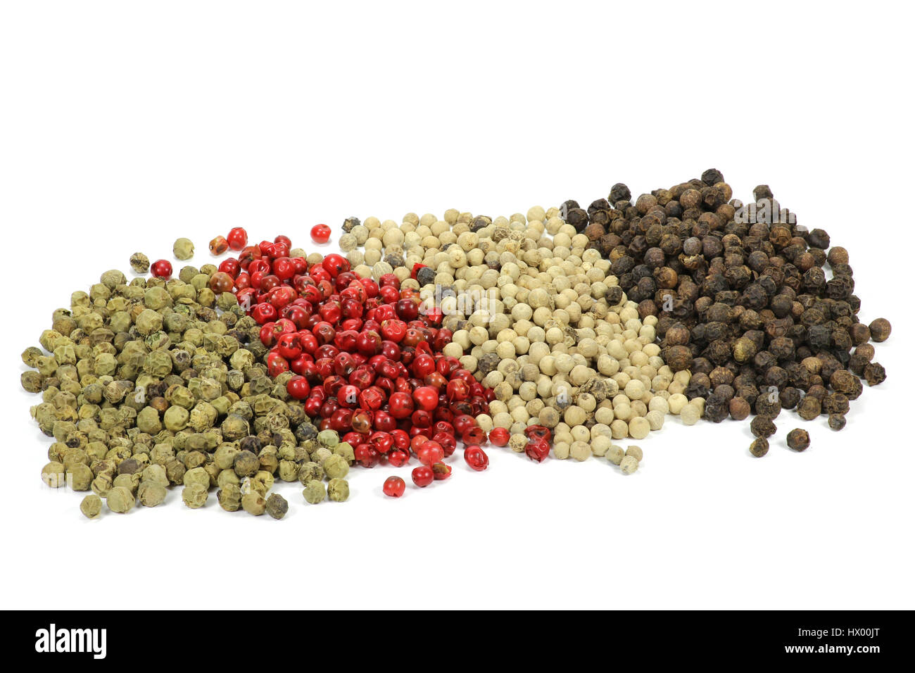 different colored peppercorns isolated on white background Stock Photo