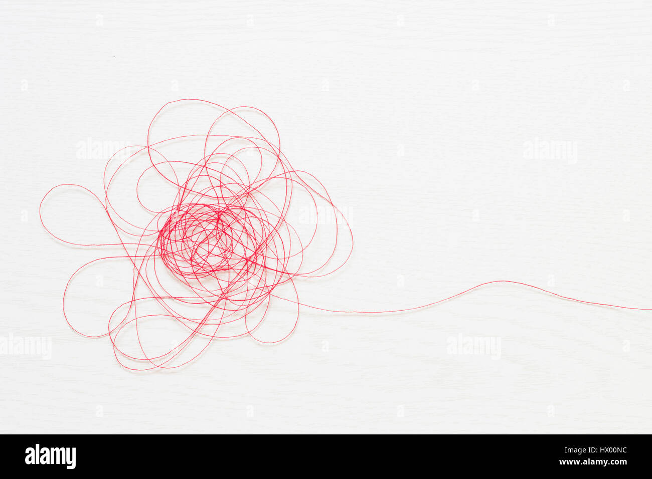 Red thread on white background Stock Photo - Alamy