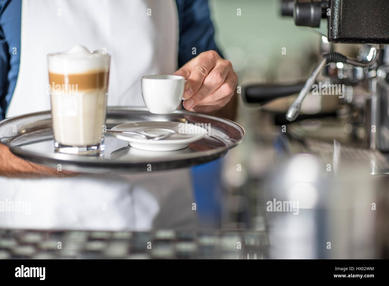 Barista serving Latte Macchiato Stock Photo