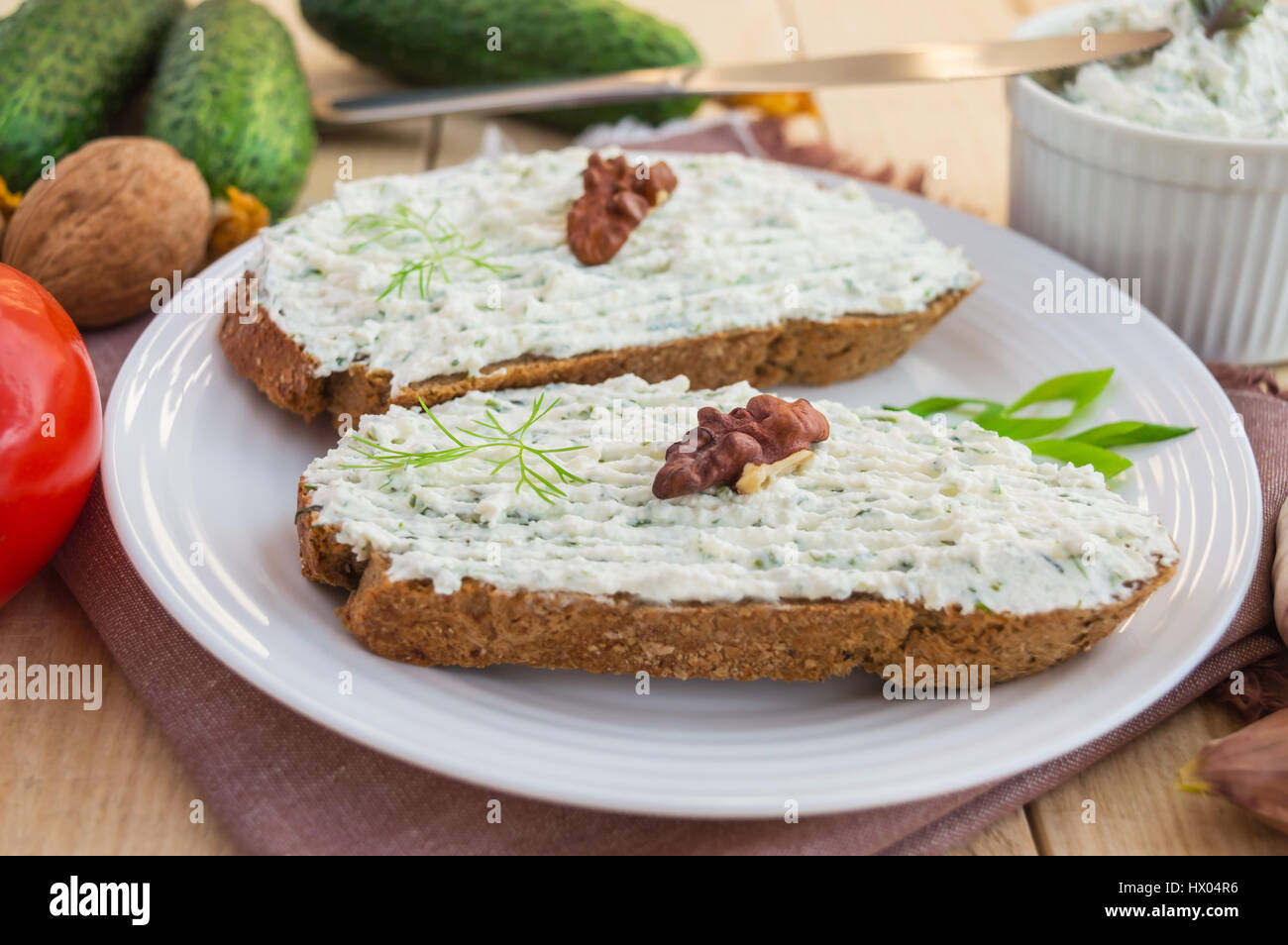 Nutritious sandwich with cottage cheese paste on rye bread on a white