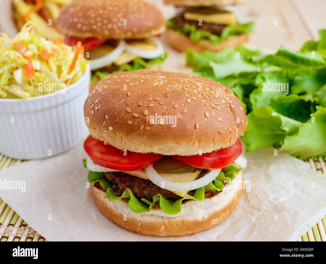 Sandwich home of the hamburger buns soft, juicy burger, cheese, tomato, parsley. Salad savoy