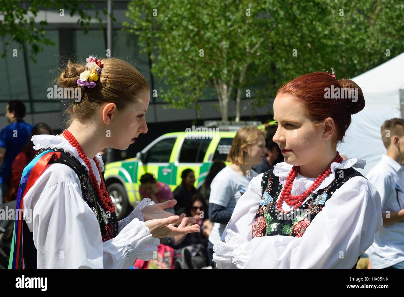LONDON  ENGLAND 9 May 2015: Two girls in traditional polish costume chatting Stock Photo
