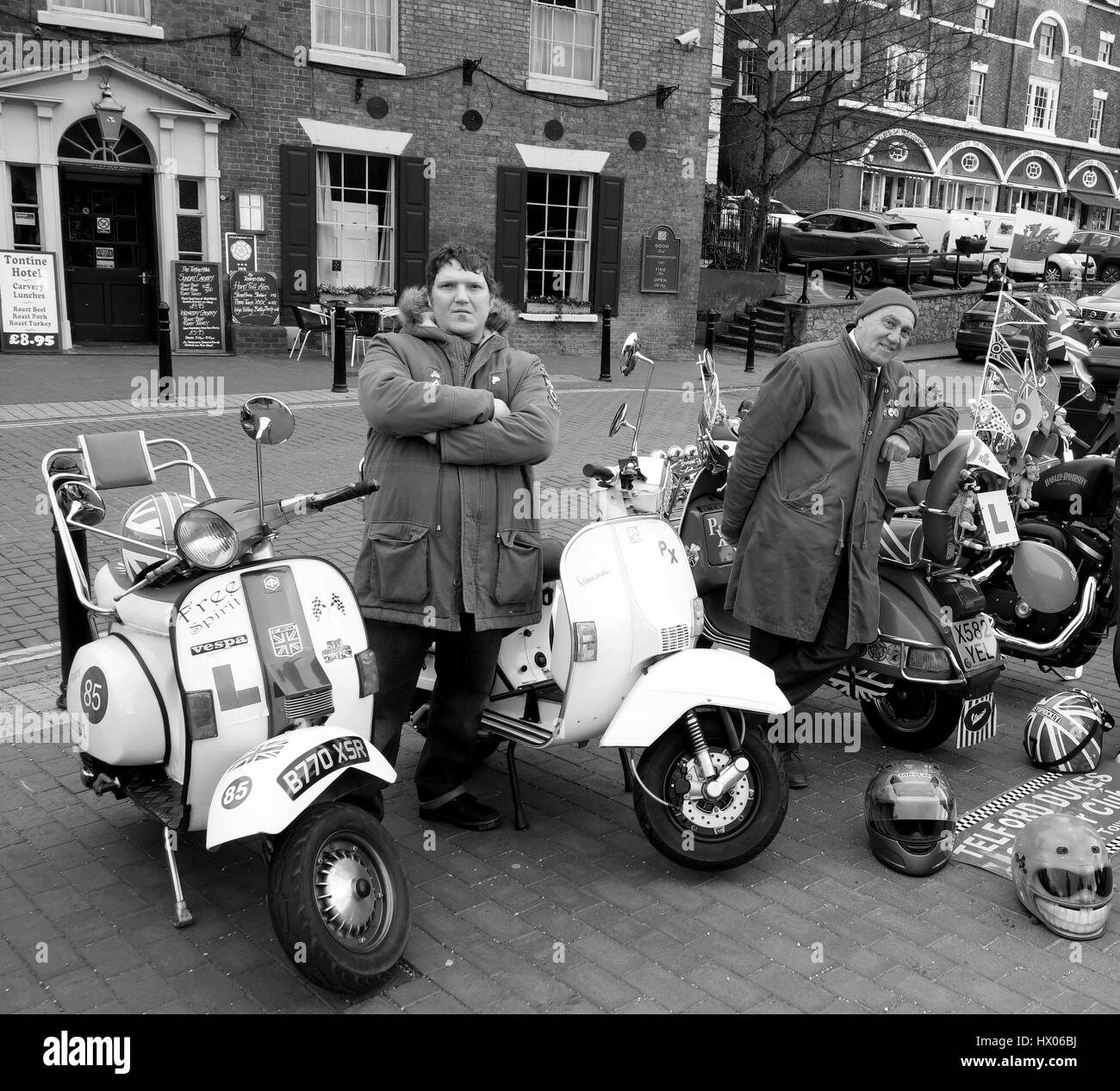 Motor scooter enthusiasts dressed in mod style 'parker coats' posing with their Vespa scooters. Stock Photo
