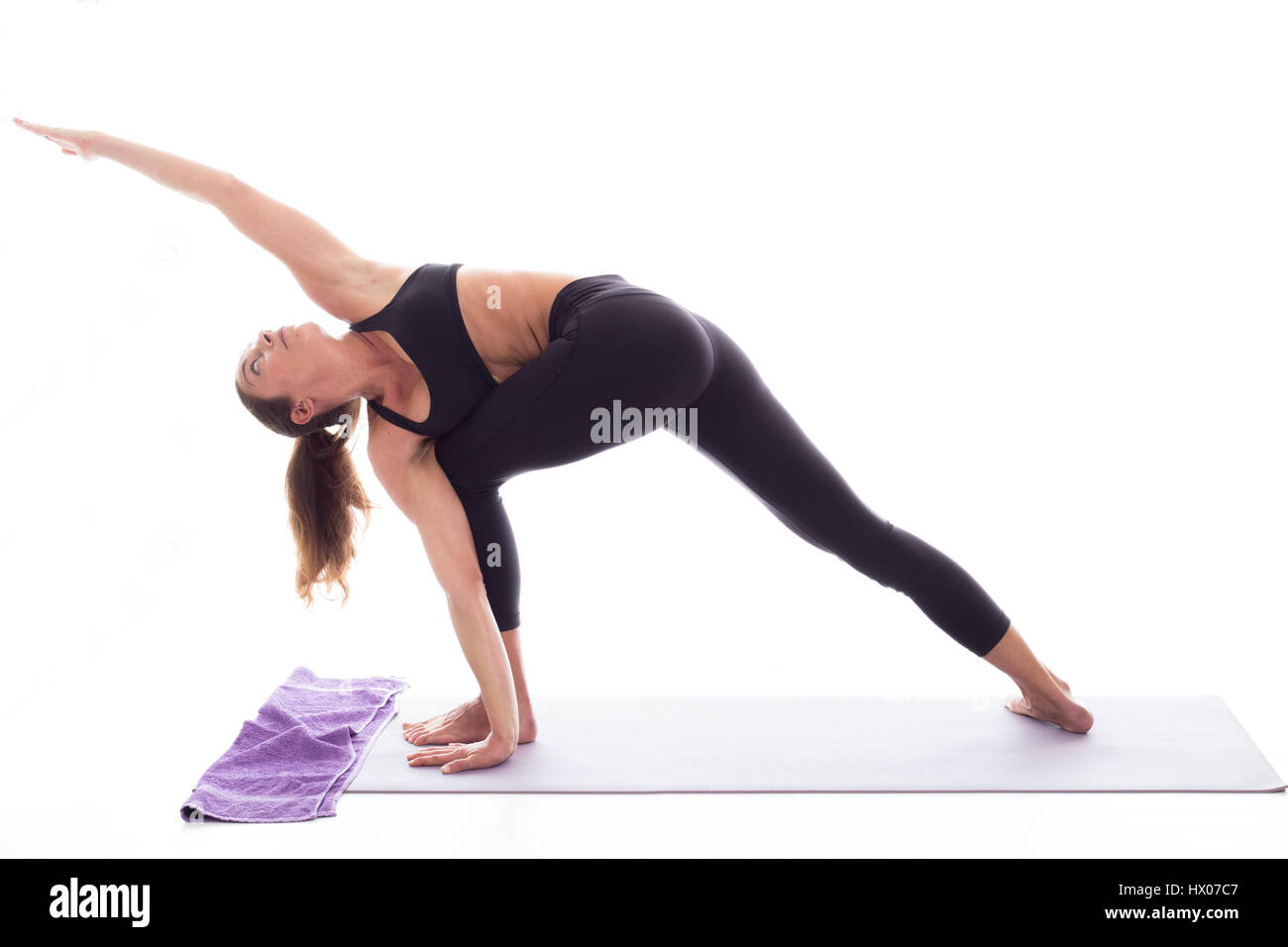 Studio shot of a young fit woman doing yoga exercises white background, Stock Photo