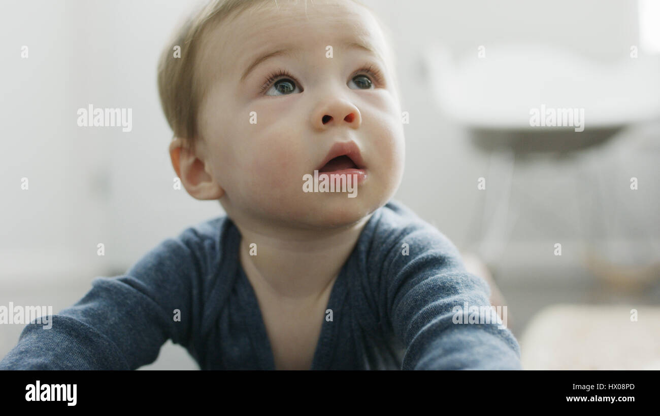 Close up of adorable inquisitive baby boy looking up Stock Photo