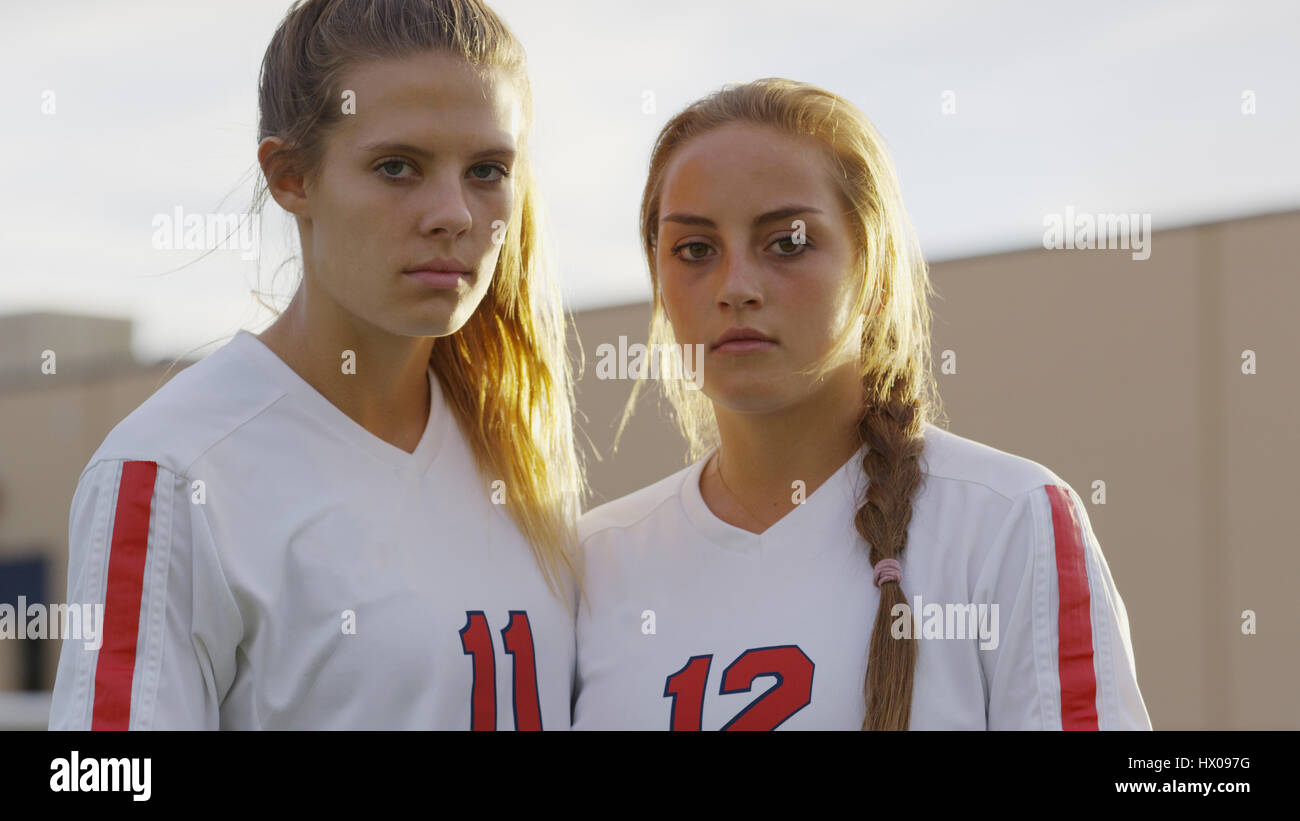 Low angle portrait of serious soccer athlete teammates standing outdoors Stock Photo