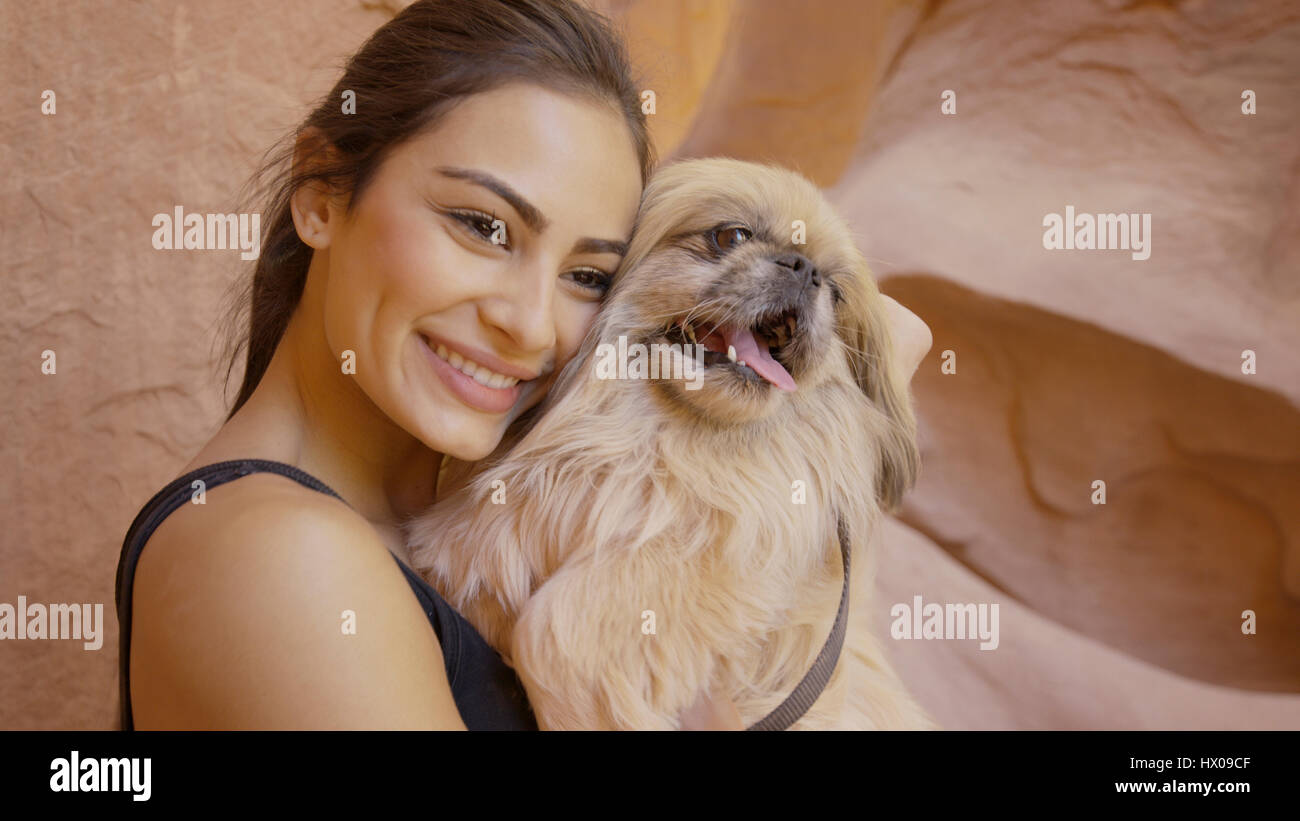 Close up of portrait of smiling woman holding pet dog Stock Photo