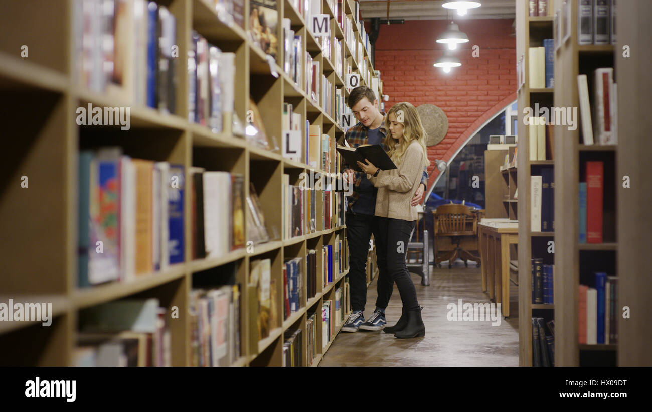 Selective focus view of boyfriend and girlfriend reading book in bookstore Stock Photo