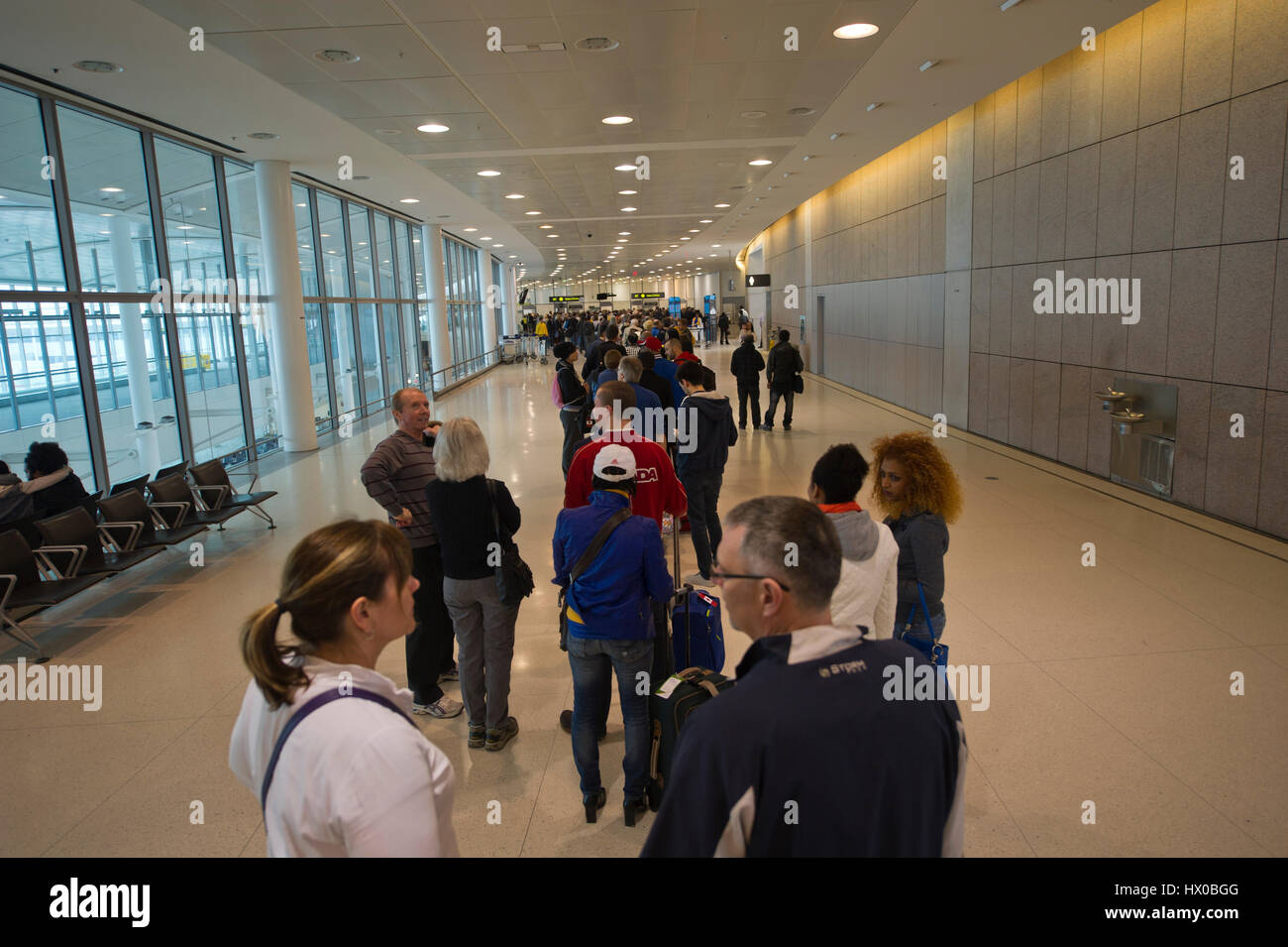 Very long line-up of people departing for Caribbean vacations at security check at Pearson Airport, Toronto Stock Photo