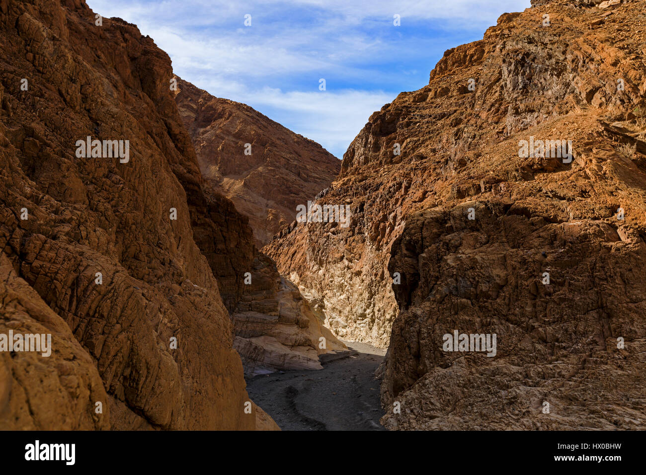 This view looks down through a section of copper-colored narrows of Mosaic Canyon in Death Valley National Park, California, USA. Stock Photo