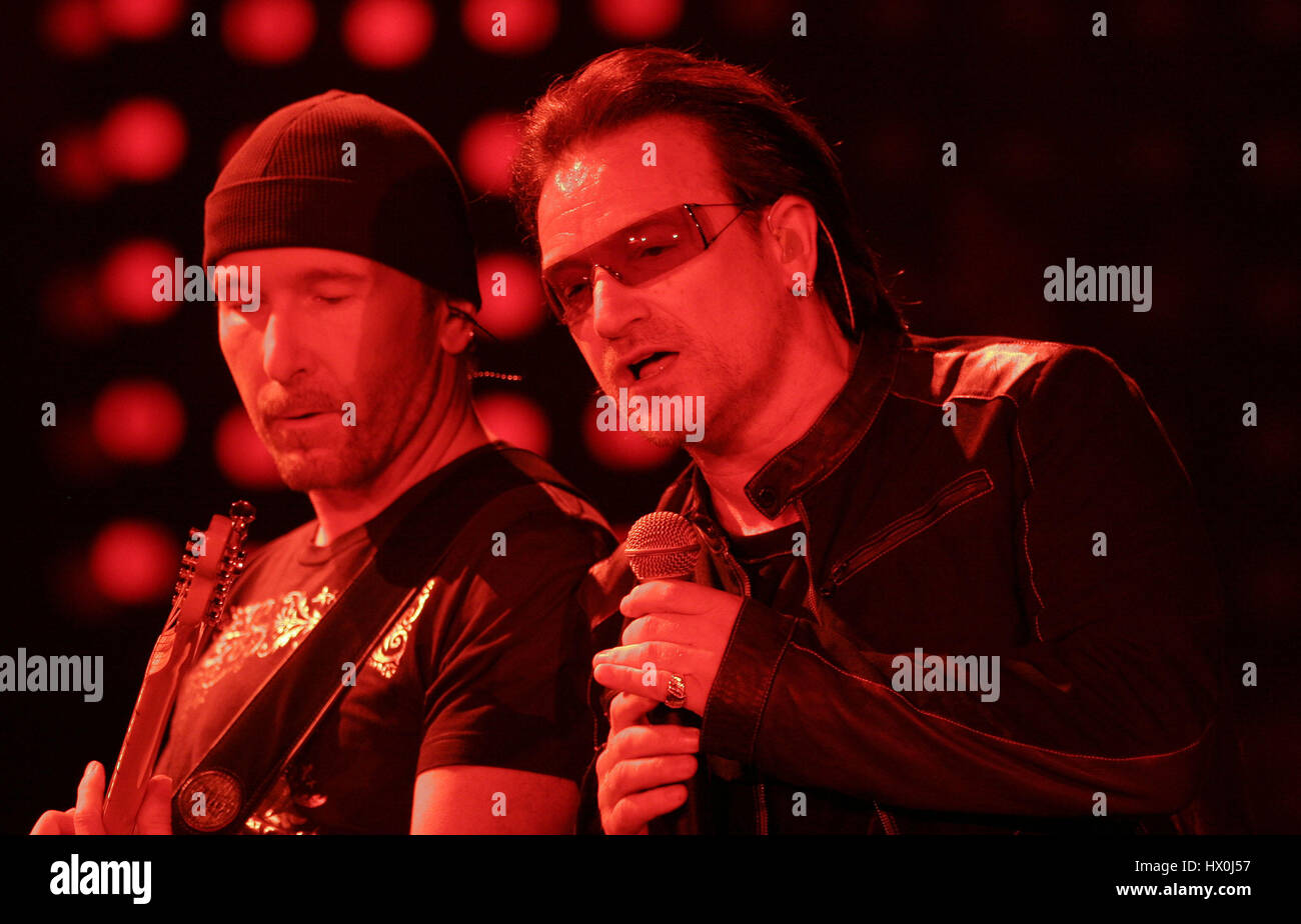 Lead singer of U2, Bono, with The Edge, in concert in San Diego, CA on