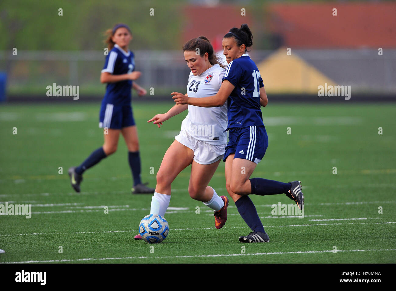 Opposing players battling for control of the ball.during a high school soccer match. USA. Stock Photo