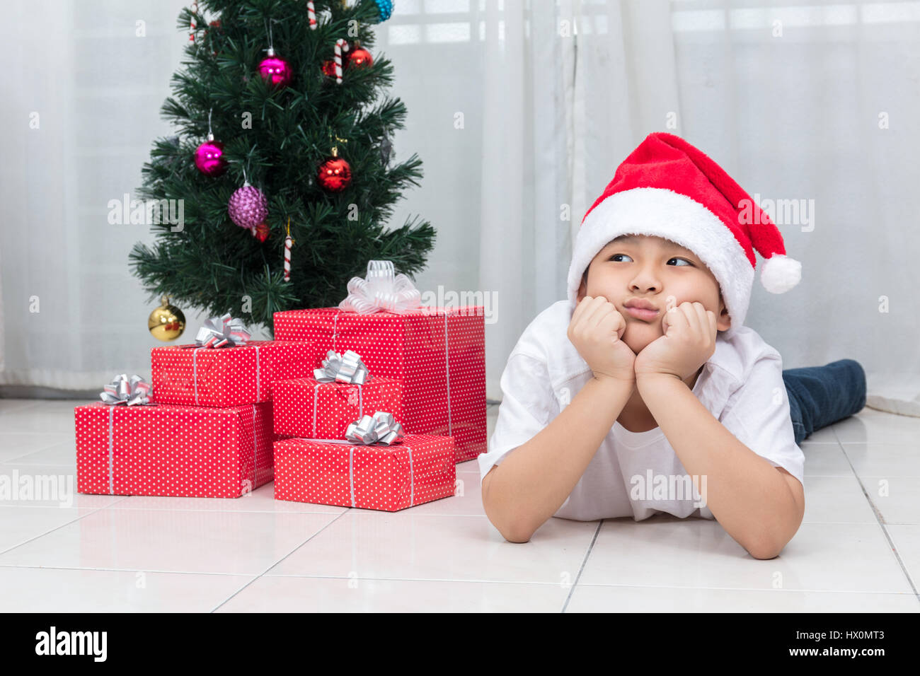 Asian Chinese little boy showing bored expression with Christmas