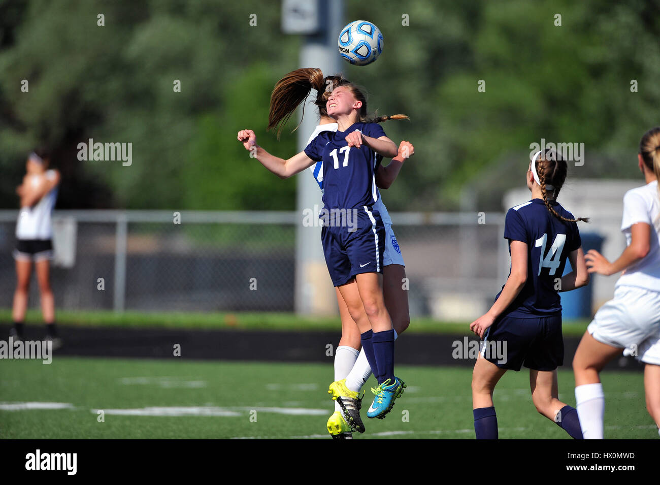 High school player attempting header during competitive match. Stock Photo