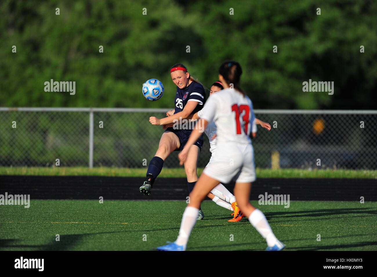 A player delivering a cross that would be headed in by teammate for a goal during a high school match. USA. Stock Photo
