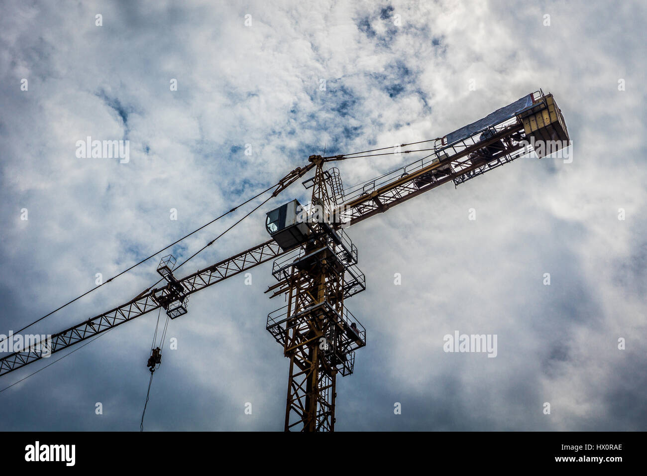 big crane for building construction with cloudy sky as background photo ...