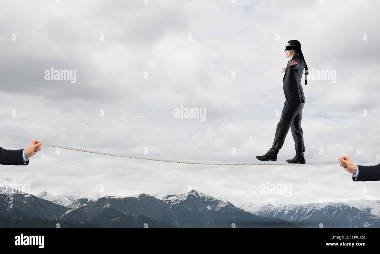 Business concept of risk support and assistance with man balancing on ...