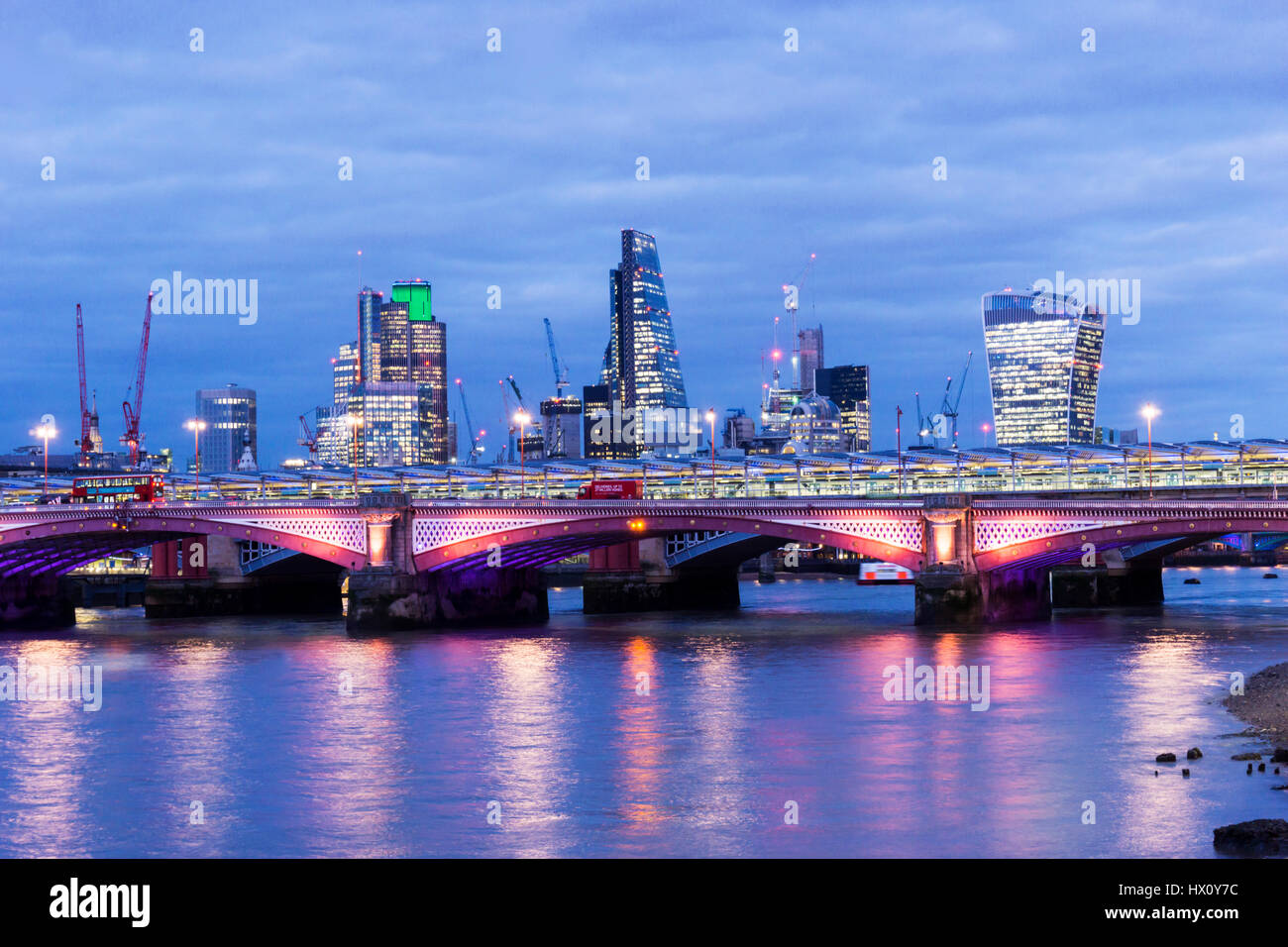 City of London skyl;ine across River Thames at night. Blackfriars Bridge in foreground. Stock Photo
