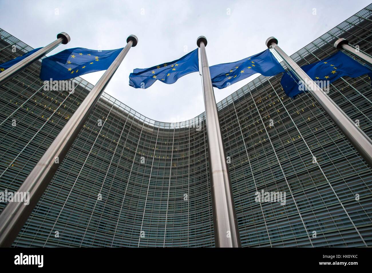 EU flags wave next to the Berlaymont building, headquarters of the European Commission in Brussels, Belgium Stock Photo