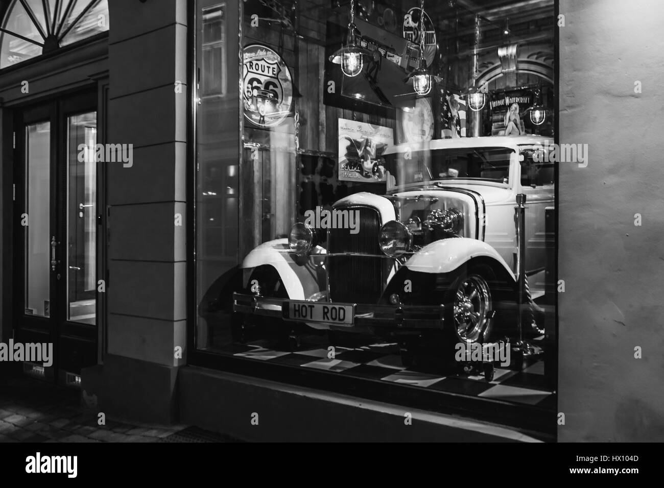 Riga, Latvia - March 20, 2017:  white Hot Rod in Rout 66 american vintage bar at night,  black and white Stock Photo