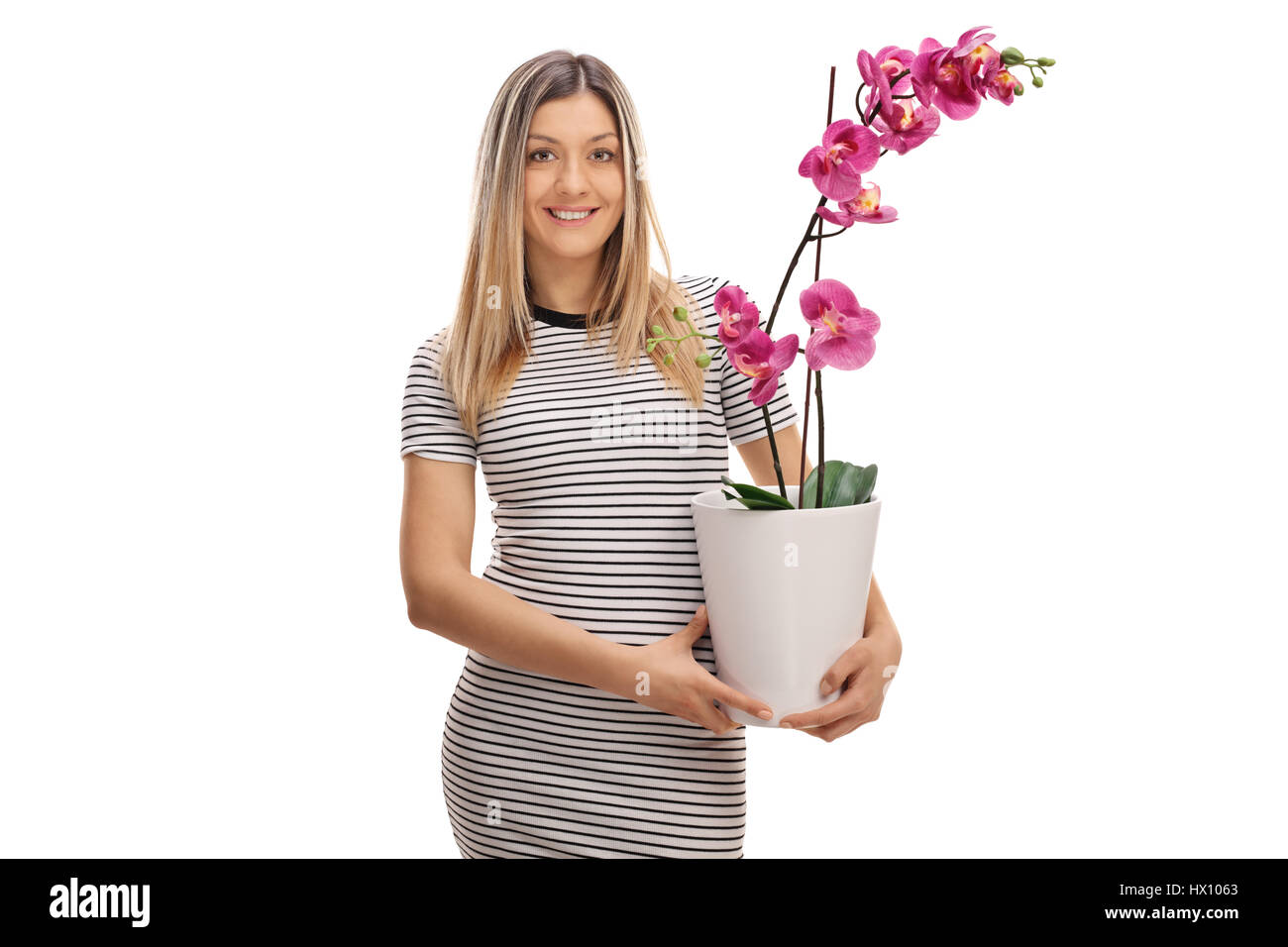 Young woman holding an orchid flower in a pot isolated on white background Stock Photo