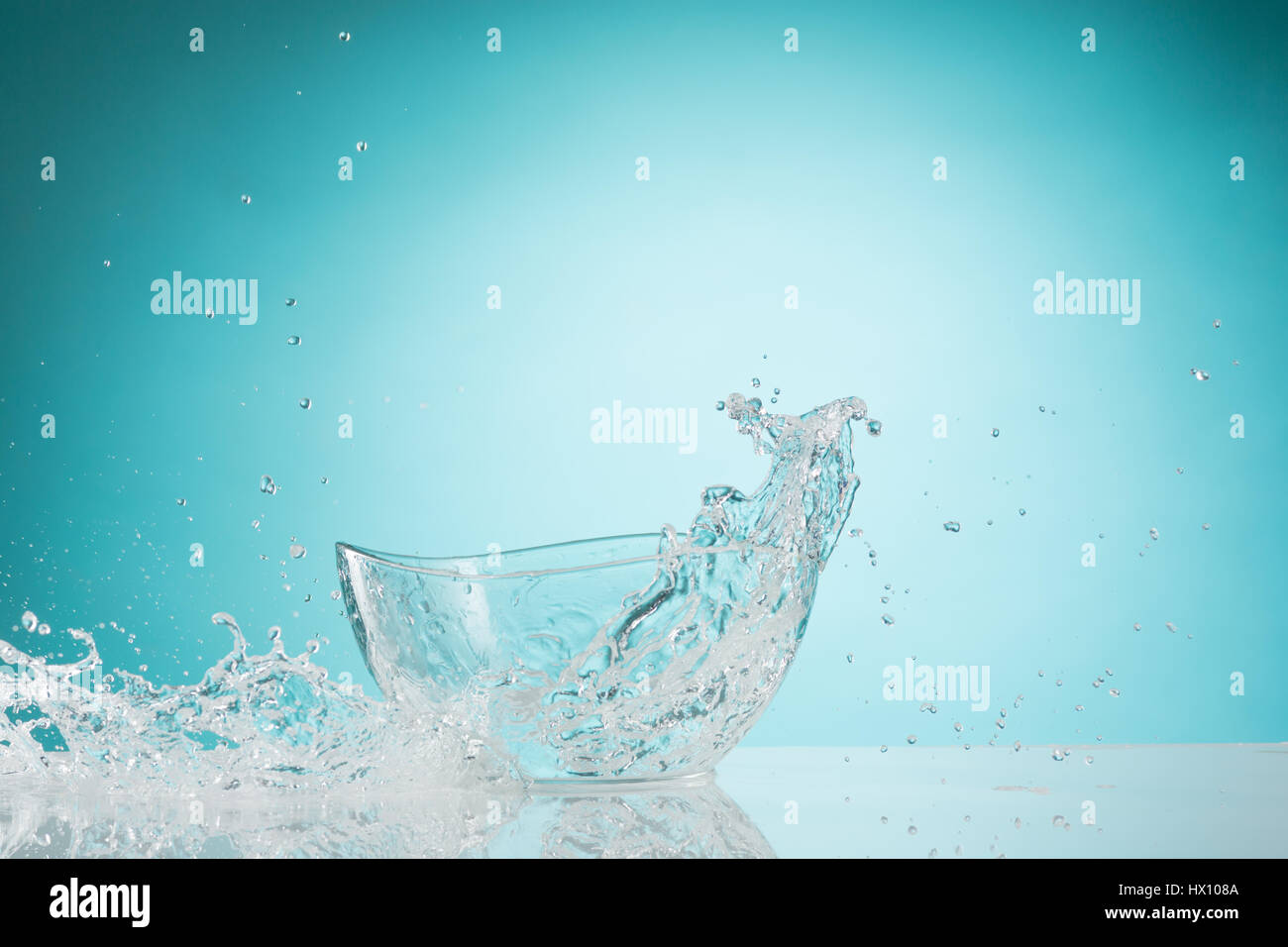 The water splashing to glass bowl on white background Stock Photo - Alamy